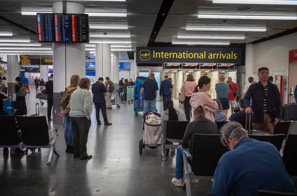 stock image People wait for airline passengers to arrive at International Arrivals at London Gatwick Airport North Terminal, UK.