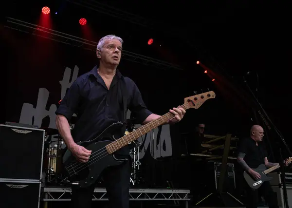 stock image Guildford / UK - Jun 29 2024: Original band member Jean-Jacques Burnel performs with The Stranglers at Guilfest music festival, Guildford, Surrey, UK.