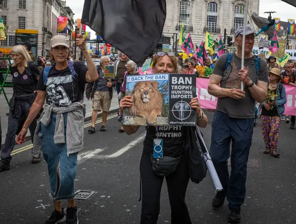 stock image London / UK - Jun 22 2024: Activists protest against big game trophy hunting  at the Restore Nature Now march for environmental protections. Organisations including the RSPB, WWF,  National Trust, Extinction Rebellion and others united for the march.