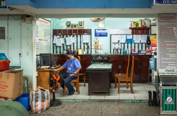 stock image A uniformed security guard at Con Market in Danang, Vietnam, looks at a computer in his office.