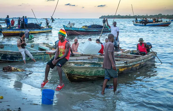 Stock image Fishermen wait with their traditional wooden dhow boat in the evening at Kivukoni Fish Market, Dar es Salaam, Tanzania,