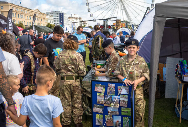 Young Army Cadets in military uniform at a display stand in the military exhibition alongside the annual Eastbourne Airbourne, an international airshow