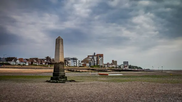 stock image The Crowstone, or Crow Stone, the old marker for the seaward limit of the Port of London Authority jurisdiction in the Thames Estuary at Chalkwell in Essex, UK at low tide.