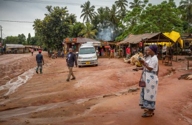 People at the market after unseasonal heavy rain in Msanga in rural Tanzania. clipart