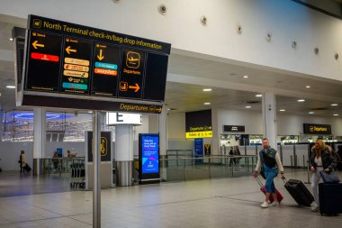 Check in information sign at departures in North Terminal, Gatwick Airport, London, UK. clipart