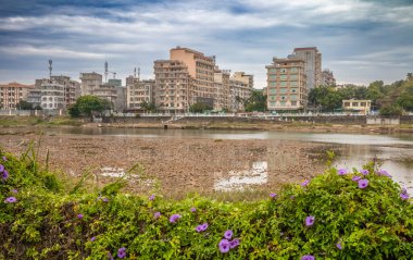 Looking across the Ka Long river in Mong Cai, Vietnam, across the international border to Dongxing in China. clipart