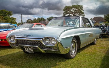 A silver 1963 Ford Thunderbird on display at a classic car show in Storrington, West Sussex, UK. clipart