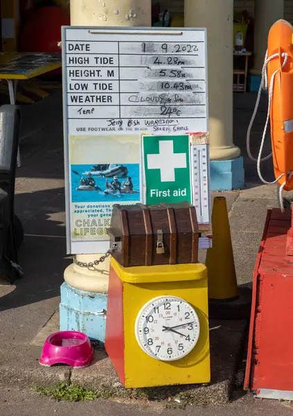 stock image Tide information and first aid equipment at a lifeguard station on Chalkwell Beach in Essex, UK.