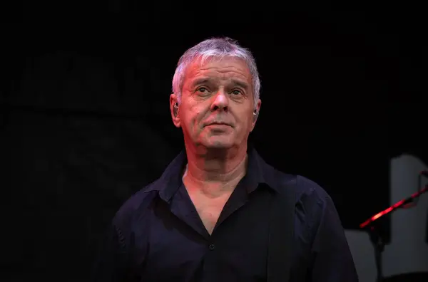 stock image Guildford / UK - Jun 29 2024: Original band member Jean-Jacques Burnel performs with The Stranglers at Guilfest music festival, Guildford, Surrey, UK.