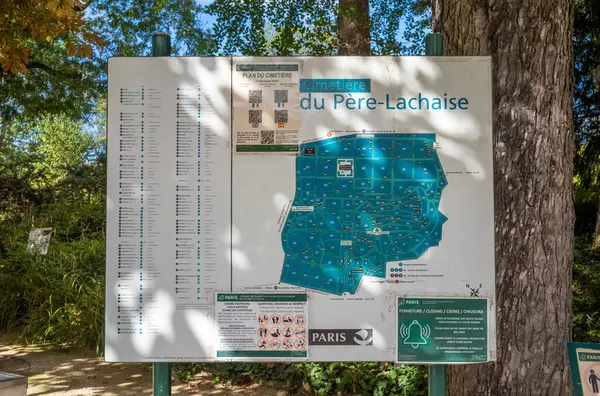 stock image An information board at the entrance to Pere Lachaise Cemetary in Paris, France, showing a map, giving information and the locations of the graves of famous people buried here.