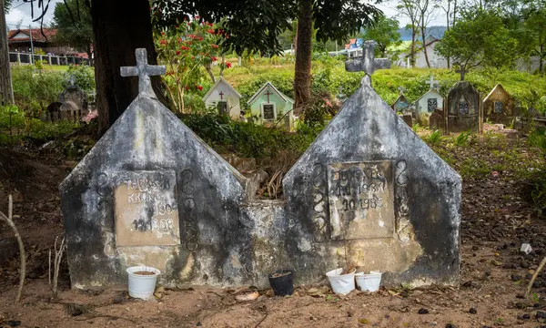 stock image The graves of a husband and wife in a Catholic cemetary opposite Kon Xom Luh Catholic Church, Kon Ray, Kontum, Vietnam