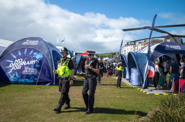 Two policemen walk through the military exhibition alongside the annual Eastbourne Airbourne, an international airshow