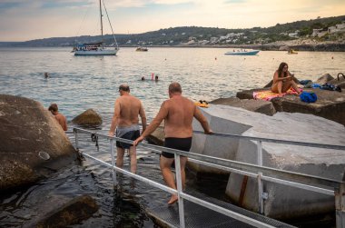 İtalya 'nın Apulia kentindeki Castro Marina' yı koruyan iki orta yaşlı İtalyan kayaların arasından denize giriyor..