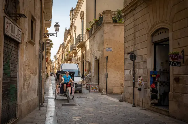 İtalya 'nın antik şehri Lecce, Apulia' da dar bir sokakta beyaz bir minibüs tarafından takip ediliyor..
