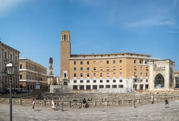 stock image The rationalist architecure Fascist-era Palazzo dell'INA (Istituto Nazionale delle Assicurazioni) next to the Roman amphitheatre in the heart of the ancient city of Lecce, Apulia, Italy.