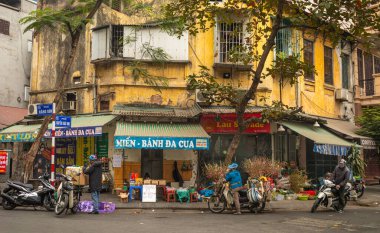 Geleneksel Hoa Dao, ya da şeftali çiçekleri, ve diğer Lunar yeni yıl hediyeleri Eski Mahalle, Hanoi, Vietnam 'da bir sokak köşesinde paketlenip satılıyor..