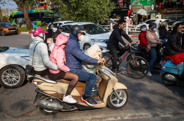 Ebeveynler ve çocukları motosikletle yeni yılın ilk gününde ya da Tet, Hanoi, Vietmam