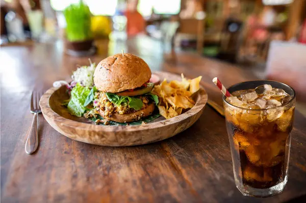 stock image a tasty burger and cola on the table.