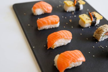 Karanlık tepside hazırlanmış bir suşi.