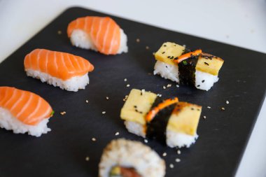 Karanlık tepside hazırlanmış bir suşi.