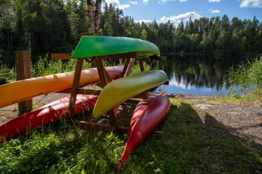 Kiralık bir istasyonda körfezin yakınındaki ahşap bir askıda renkli kanolar.