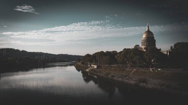 Tranquil morning at the West Virginia State Capitol by the river clipart