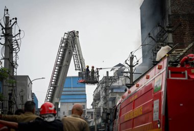 NEW DELHI, INDIA - JULY 24, 2024: Firefighters seen trying to douse off fire gutted inside a plastic factory at Narela Industrial Area on July 24, 2024 in New Delhi, India.  clipart