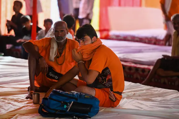 stock image NOIDA, INDIA - JULY 25, 2024: Kanwariya carries holy water collected from Ganga River in Haridwar during Kanwar Yatra at Sector 14A on July 25, 2024 in Noida, India. The Gautam Budh Nagar administration is on its toes to ensure proper arrangements 