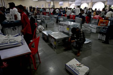 NAVI MUMBAI, INDIA - MAY 18, 2024: Election officials carry a (EVM) ballot box for distribution for constituency election scheduled on 20th May 2024 at Agri Koli Bhavan Nerul, on May 18, 2024 in Navi Mumbai, India. clipart