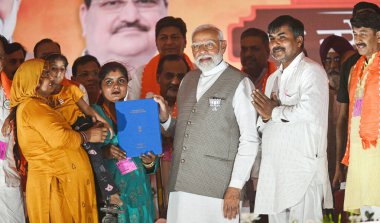 NEW DELHI, INDIA - MAY 18, 2024: Prime Minister Narendra Modi meeting with CAA beneficiary Family during a Loksabha election campaign rally in Northeast Delhi on May 18, 2024 in New Delhi, India. clipart