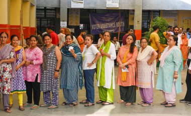 Voters at a polling station during the Sixth phase of voting for General Lok Sabha elections , at Ashraf Ali Road school on May 25, 2024 in New Delhi, India.   clipart