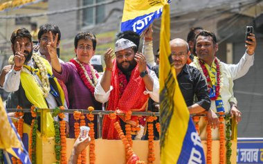 NEW DELHI, INDIA - MAY 4, 2024: AAP candidate from East Delhi Kuldeep Kumar for upcoming Loksabha Elections, along with Delhi minister and AAP leader Atishi seen during a Roadshow before filing the Nomination Papers for Elections at Mandawali Area clipart