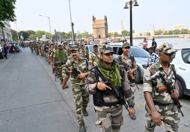 MUMBAI, INDIA - MAY 18, 2024: Mumbai Police personnel of COlaba Police station along with BSF,CISF, CRF, MSB and Homegaurd held a Route March in their jurisdiction, ahead of upcoming Lok Sabha election 2024, at Gateway Of India, on May 18, 2024 clipart