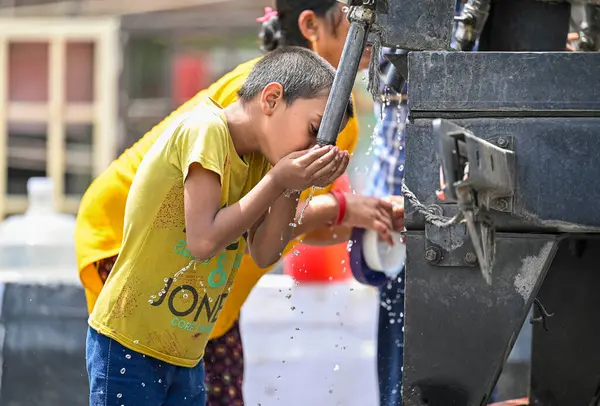 NEW DELHI, INDIA - 30 Mayıs 2024 'te Hindistan' ın Yeni Delhi kentinde, kavurucu sıcak hava dalgalarından dolayı susuzluğunu gideren bir çocuk. Fotoğraf: Raj K Raj / Hindustan Times)