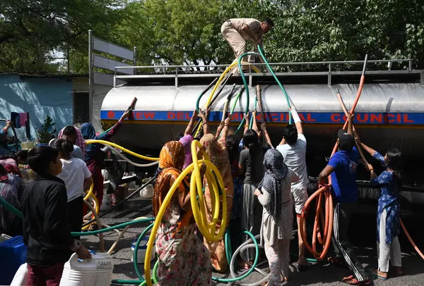 NEW DELHI, INDIA - 31 Mayıs 2024: Delhi Jal Board (DJB) su tankeri sakinleri ve çocukları, Vivekananda Kamp Chanakyapuri 'de yaz aylarında yaşanan bir su krizinin ortasında, 31 Mayıs 2024 tarihinde, Hindistan' ın Yeni Delhi kentinde. 