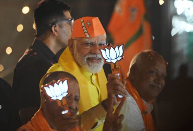 LUCKNOW, INDIA - MAY 5, 2024: Prime Minister Narendra Modi during the road show in Ayodhya in support of BJP candidate Lallu Singh from Faizabad (Ayodhya) parliamentary seat, UP CM Yogi Adityanath also present in road show at Rampath  clipart