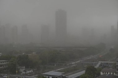 MUMBAI, INDIA - MAY 13, 2024: Dust Storm due to storm winds over city skyline of Prabhadevi, Parel on May 13, 2024 in Mumbai, India. Heavy winds, lightning, and rain lashed Mumbai and nearby regions of Thane and Palghar.  clipart