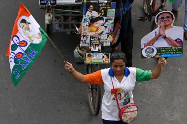 KOLKATA, INDIA - MAY 30, 2024: Trinamool Congress (TMC) supporters holding cut-out of Chairperson Mamata Banerjee during a padayatra from Jadavpur to Kalighat as part of last day Lok Sabha Election campaign on May 30, 2024 in Kolkata, India clipart