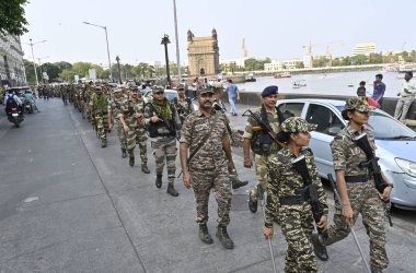 MUMBAI, INDIA - MAY 18, 2024: Mumbai Police personnel of COlaba Police station along with BSF,CISF, CRF, MSB and Homegaurd held a Route March in their jurisdiction, ahead of upcoming Lok Sabha election 2024, at Gateway Of India, on May 18, 2024 clipart