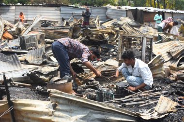 GURUGRAM, INDIA - MAY 18: Family members of victims arrive in the wreckage of a burned sleeper bus at Kundli-Manesar-Palwal (KMP) Expressway; a tourist bus carrying around 64 pilgrims from Punjab and Chandigarh  clipart