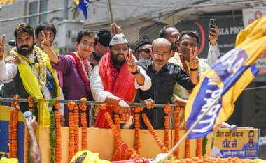 NEW DELHI, INDIA - MAY 4, 2024: AAP candidate from East Delhi Kuldeep Kumar for upcoming Loksabha Elections, along with Delhi minister and AAP leader Atishi seen during a Roadshow before filing the Nomination Papers for Elections at Mandawali Area clipart