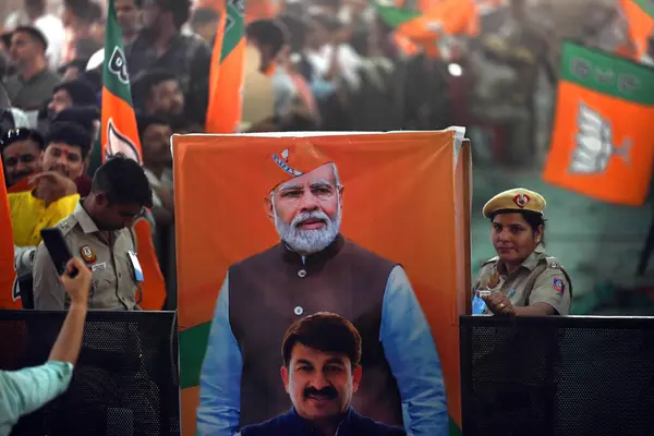 Stock image NEW DELHI, INDIA - MAY 18, 2024: Supporters of Bharatiya Janata Party (BJP hold placards of Prime Minister Narendra Modi during a public rally at Northeast on May 18, 2024 in New Delhi, India.