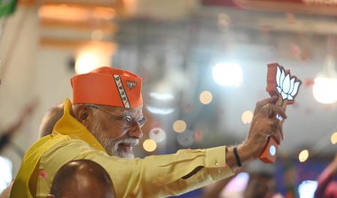 LUCKNOW, INDIA - MAY 5, 2024: Prime Minister Narendra Modi during the road show in Ayodhya in support of BJP candidate Lallu Singh from Faizabad (Ayodhya) parliamentary seat, UP CM Yogi Adityanath also present in road show at Rampath  clipart