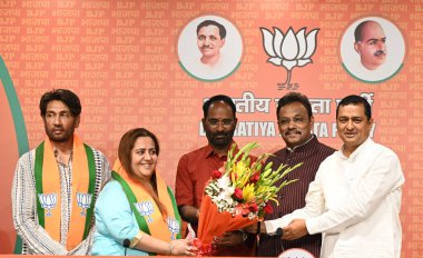 NEW DELHI, INDIA - MAY 7, 2024: Bollywood actor Shekhar Suman and former congress leader Radhika Khera join BJP in presence of General secretary of Bharatiya Janata Party Vinod Tawde, National Chief Spokesperson of the BJP Anil Baluni. clipart