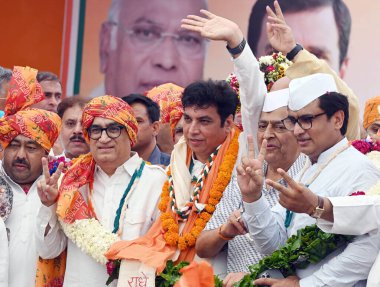 NEW DELHI, INDIA - MAY 5, 2024: DPCC Interim Chief Devendra Yadav with party leader Ajay Maken and others as he takes charge as the president of Delhi Congress, at the party office. clipart