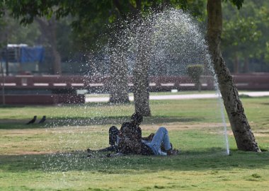 NEW DELHI, INDIA - MAY 31: People out in extreme hot weather , on May 31, 2024 in New Delhi, India. Delhi and the national capital region, which includes Gurgaon, Noida, Faridabad, Ghaziabad and more satellite towns clipart