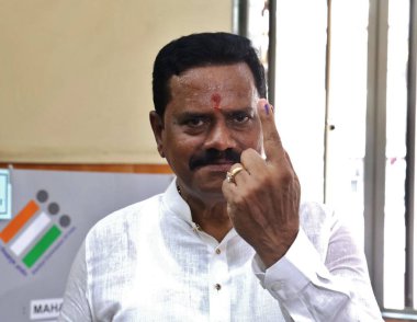 THANE, INDIA - MAY 20: Shiv Sena UBT Thane Lok Sabha candidate Rajan Vichare cast voting at St John school polling booth on May 20, 2024 in Thane, India. clipart