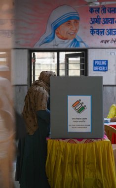 NEW DELHI, INDIA - MAY 25: Voters seen casting their vote inside a pink booth during the sixth phase of Loksabha Elections at a polling station at Jaffrabad in New Delhi, India, on Saturday, May 25, 2024.  clipart