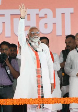 MOTIHARI, INDIA - MAY 21: Prime Minister Narendra Modi quenching his thirst during election meeting for Lok Sabha polls on May 21, 2024 in Motihari, India.  clipart