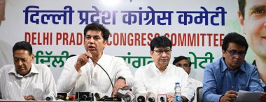 NEW DELHI, INDIA - MAY 13: DPCC President Devender Yadav along with Former President DPCC Subhash Chopra, Former Delhi Ministet Harun Yusuf, Former DPCC President Ch Anil Kumar, Ragini Nayak, Amrita Dhawan, and others addressing media persons  clipart